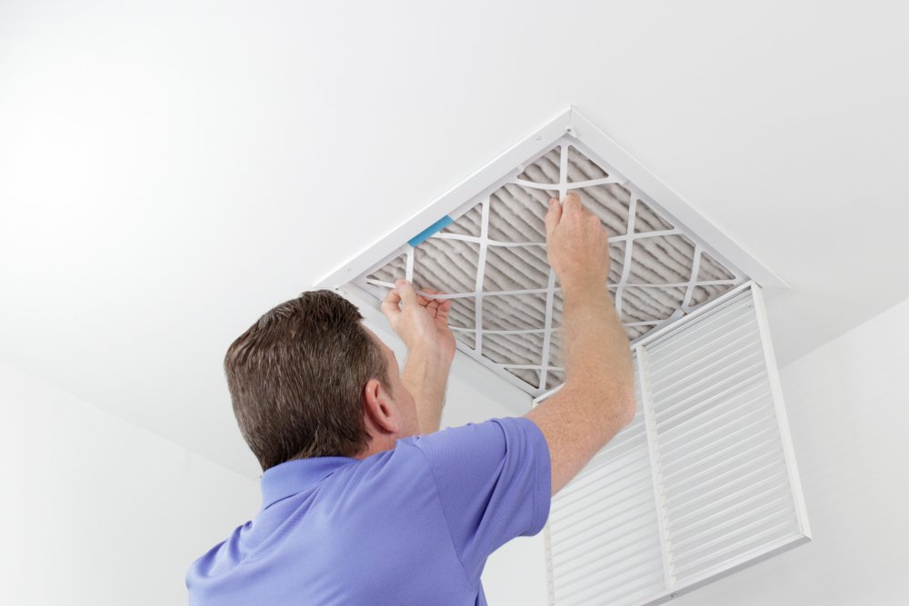 Person removing ceiling air vent